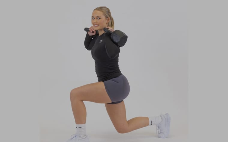 Maria mid-lunge with a kettlebell across her shoulders.